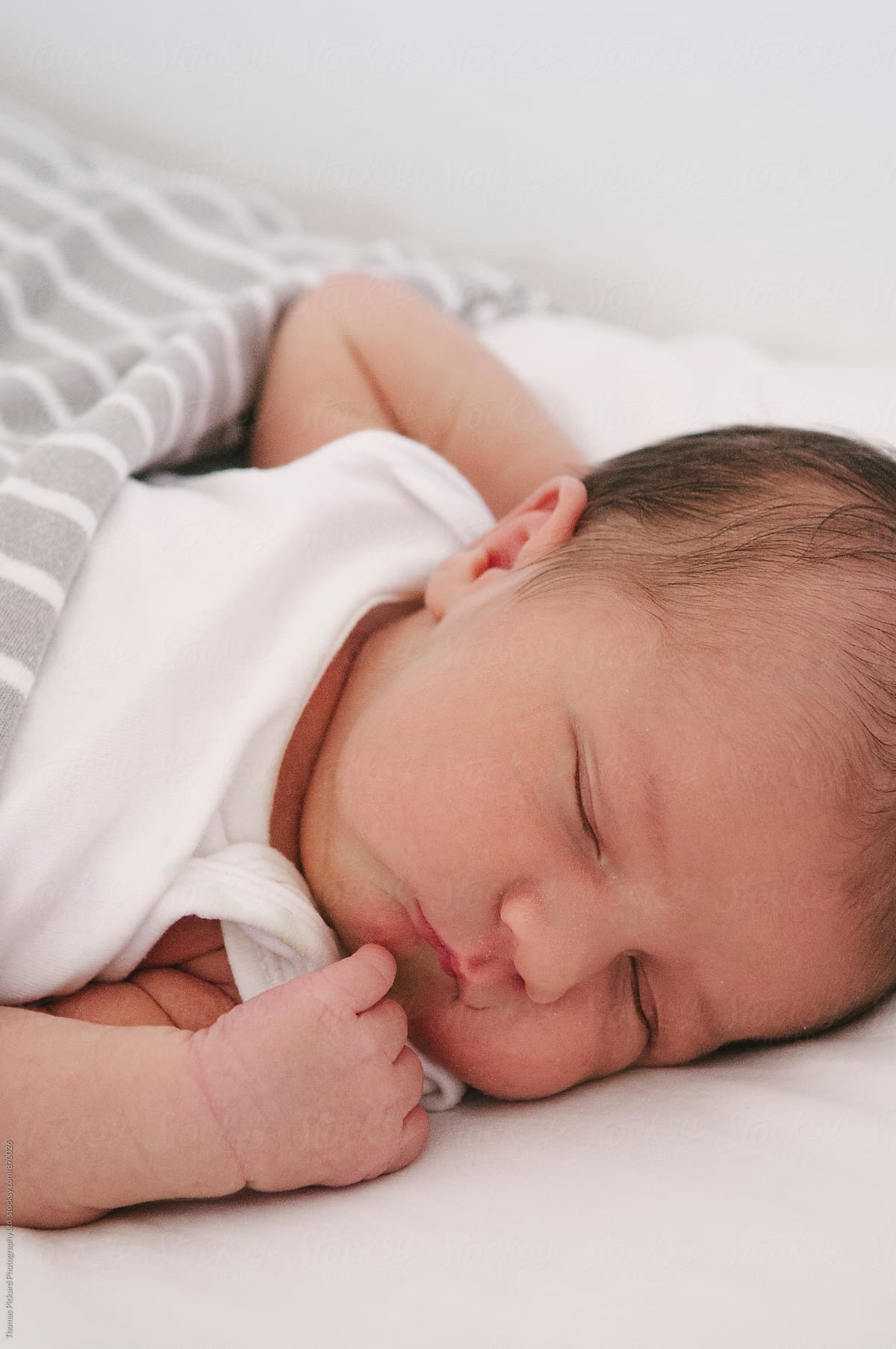 Newborn boy sleeping in a bassinet, New Zealand.