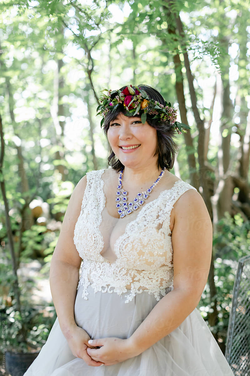 Smiling Bride Wearing Flower Crown in Forest