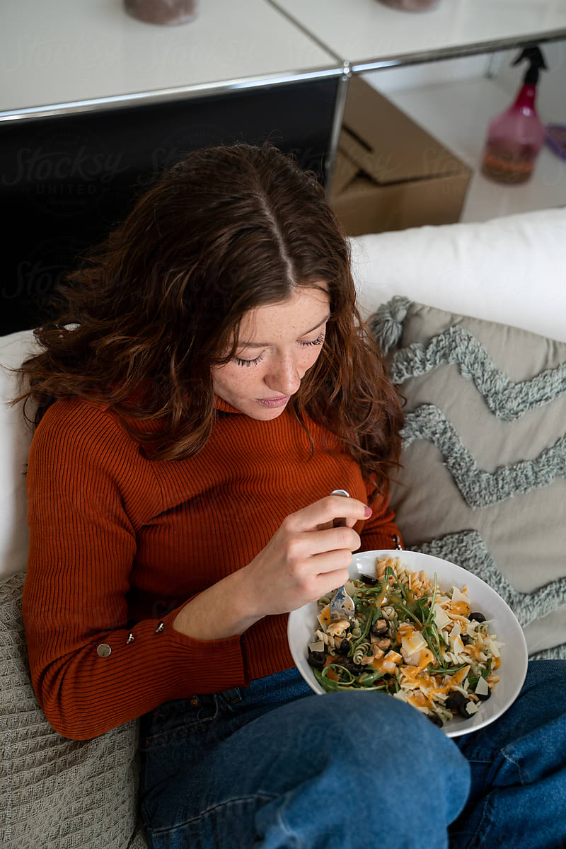 Woman eating lunch on the couch