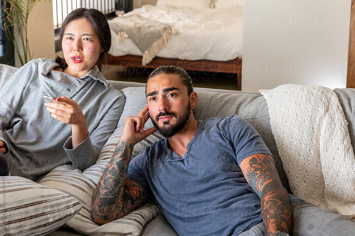 Woman and Man Browse TV on Couch