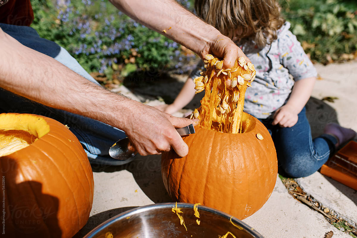 "Children Carving Pumpkin Outdoors" by Stocksy Contributor "Serena ...