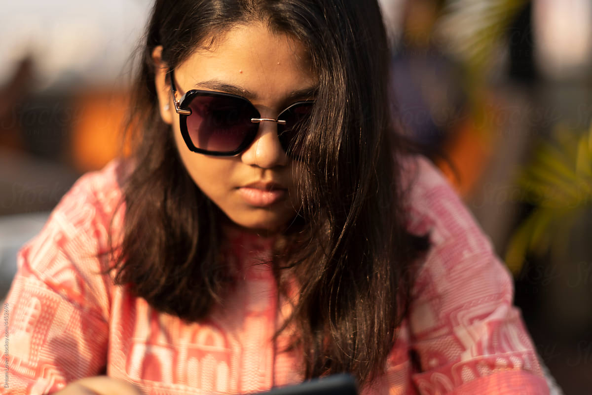 Portrait Of A Teenage Girl Wearing Sunglasses At Outdoors by Stocksy  Contributor Dream Lover - Stocksy