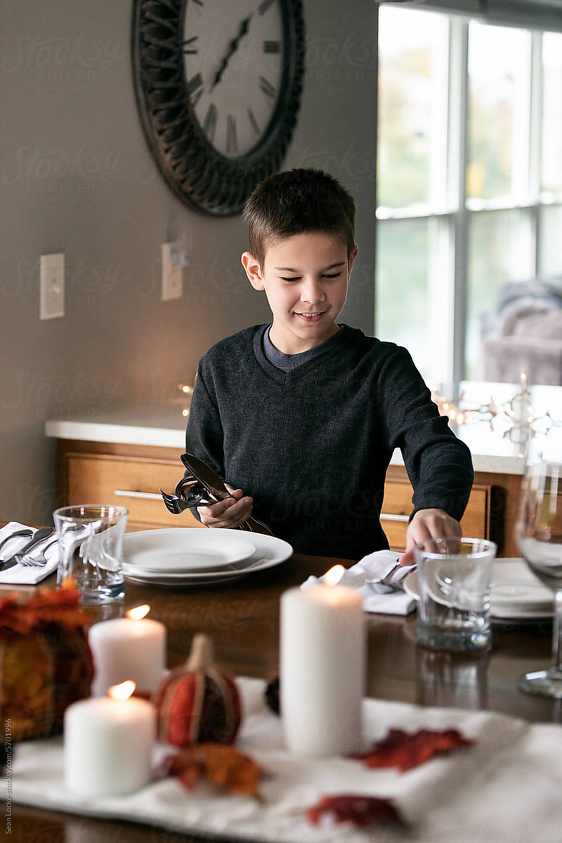 Thanksgiving: Boy Sets Table For Festive Dinner