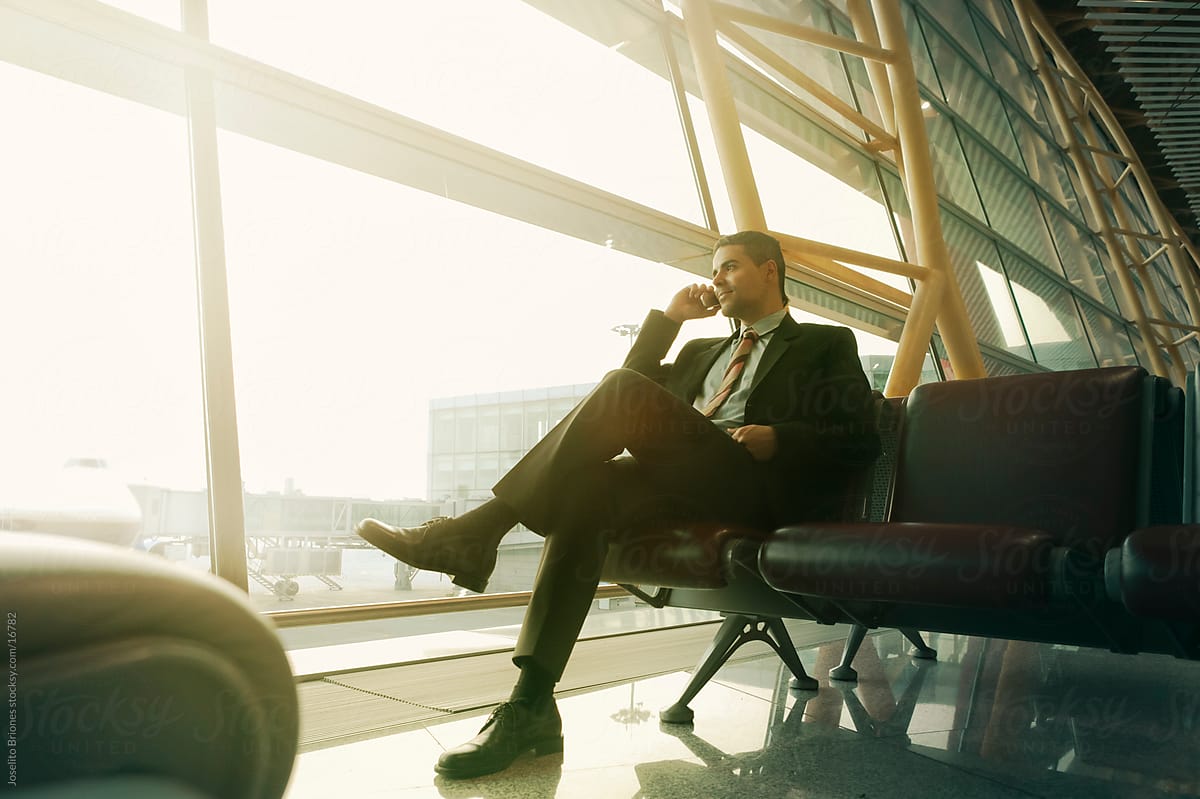 Businessman Making a Phone Call in an Airport Waiting Lounge