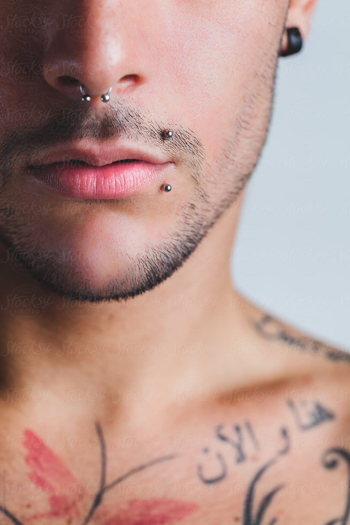 Closeup of a Sexy Young Man with Tattooed Chest