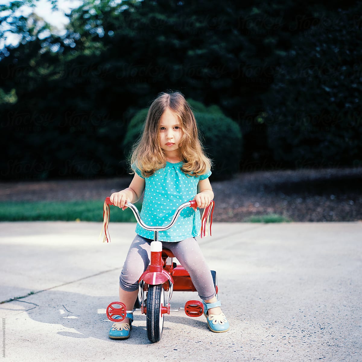 Beautiful Young Girl Sitting On A Tricycle By Stocksy Contributor Jakob Lagerstedt Stocksy 