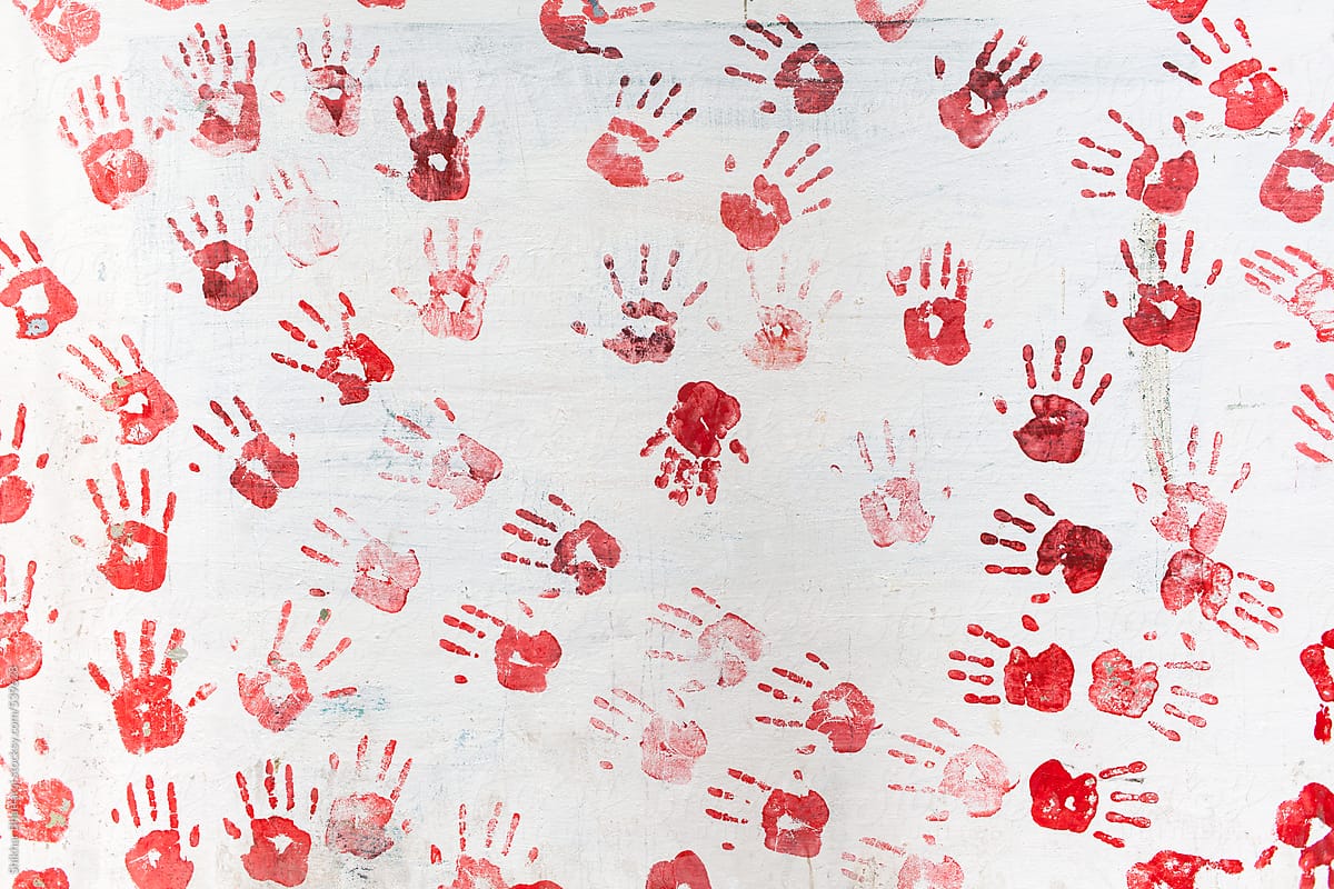 Many Hand prints on a wall.