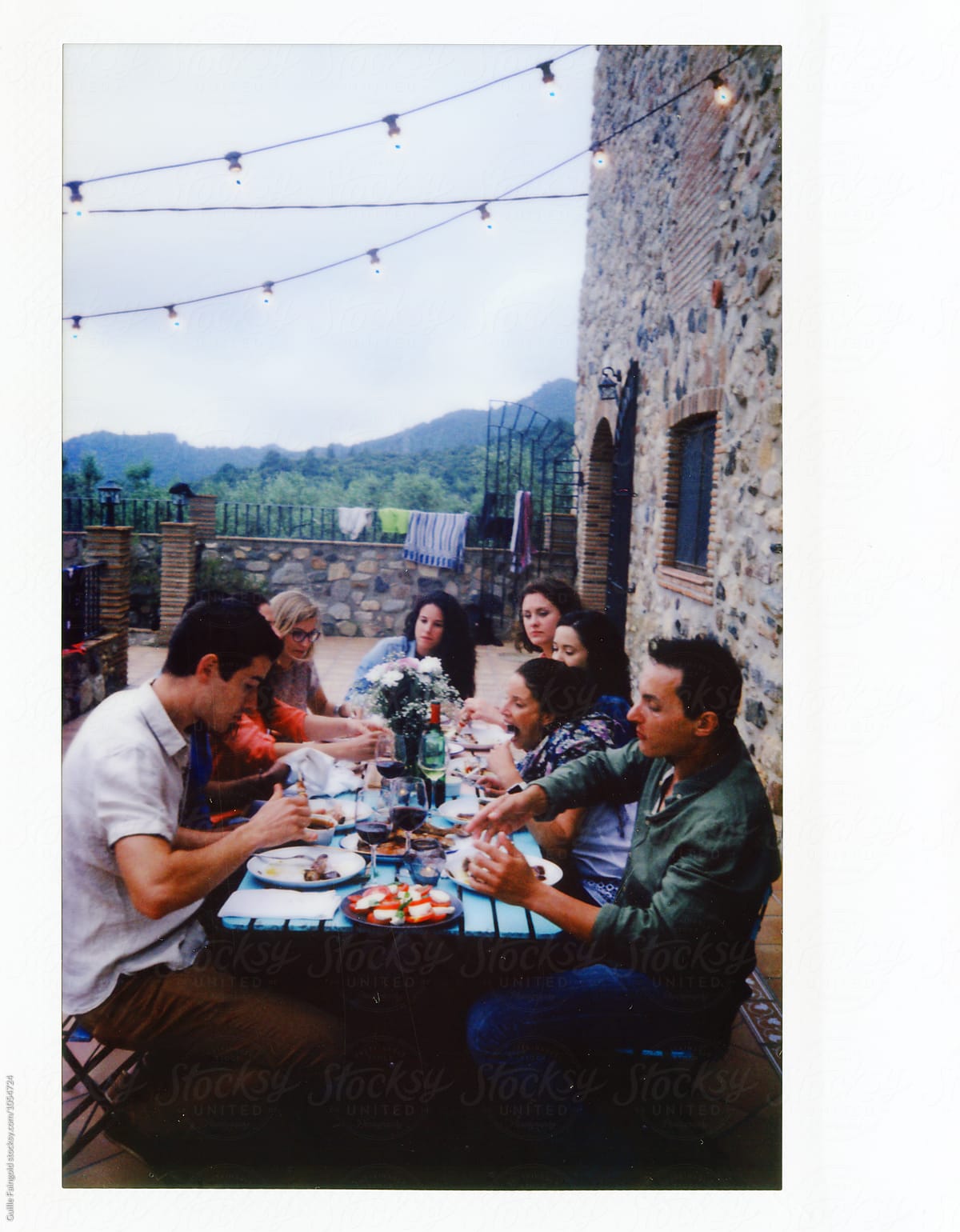 Instant shot of friends having dinner at patio