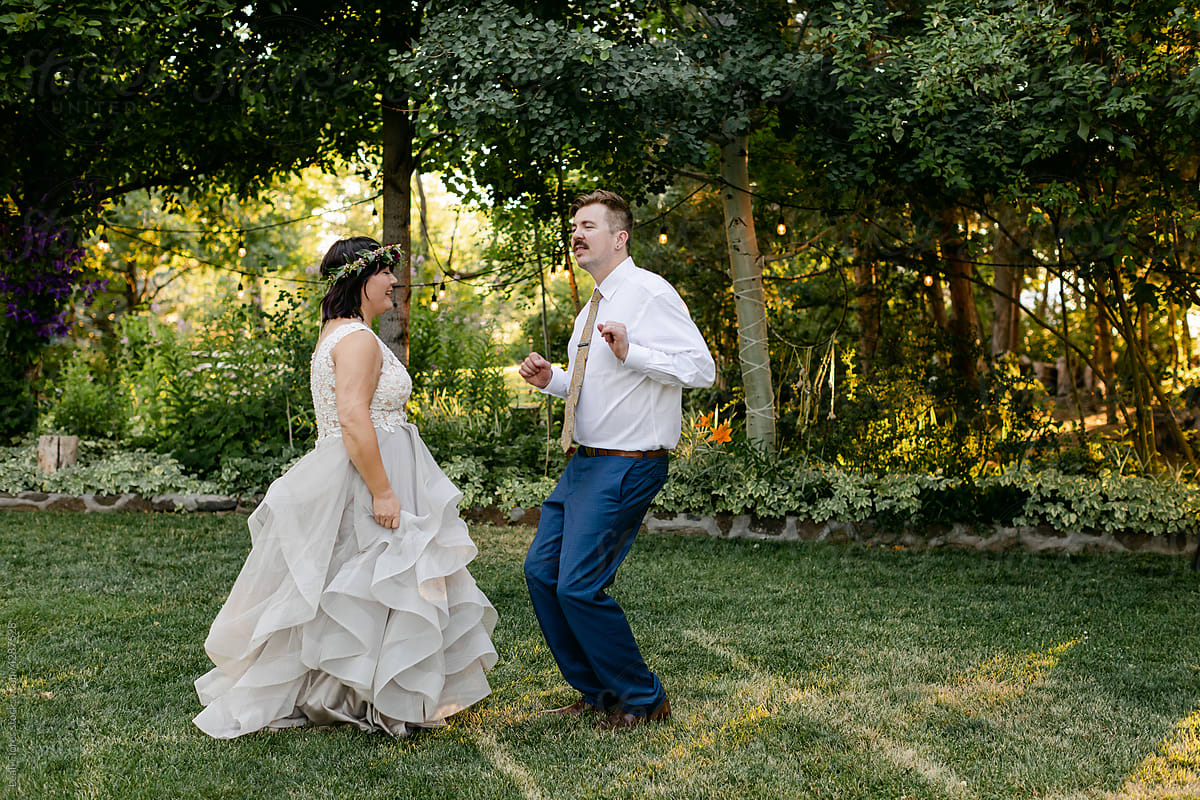 Newlyweds Dancing Around Garden Venue