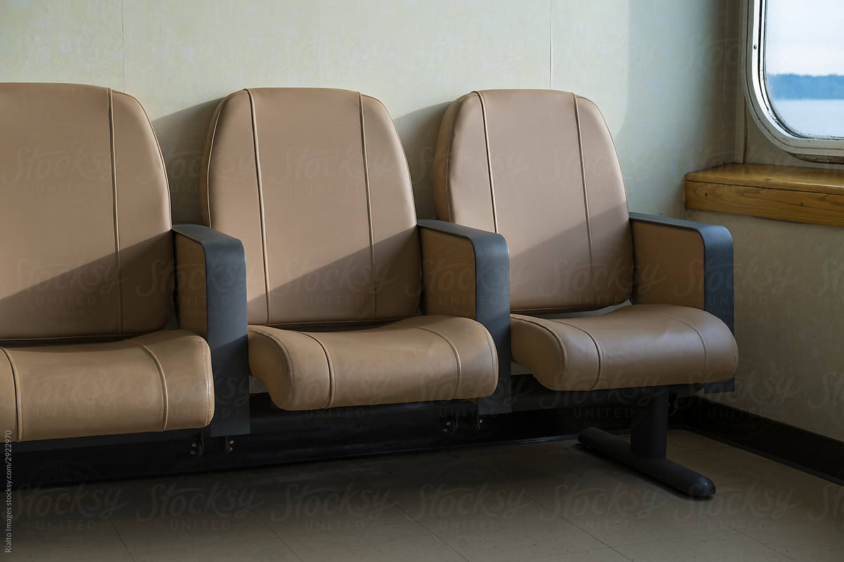 Row of beige armchairs on passenger ferry