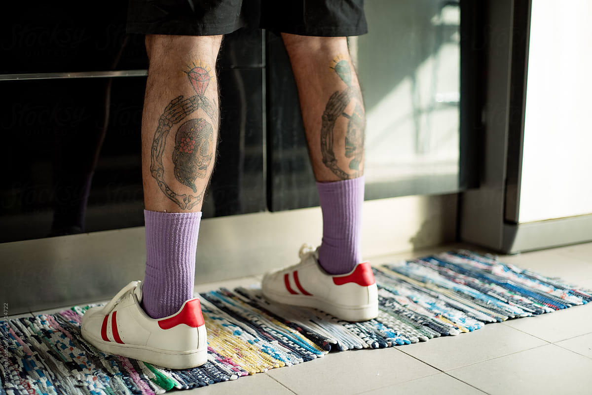 Kitchen rug and tattoed legs