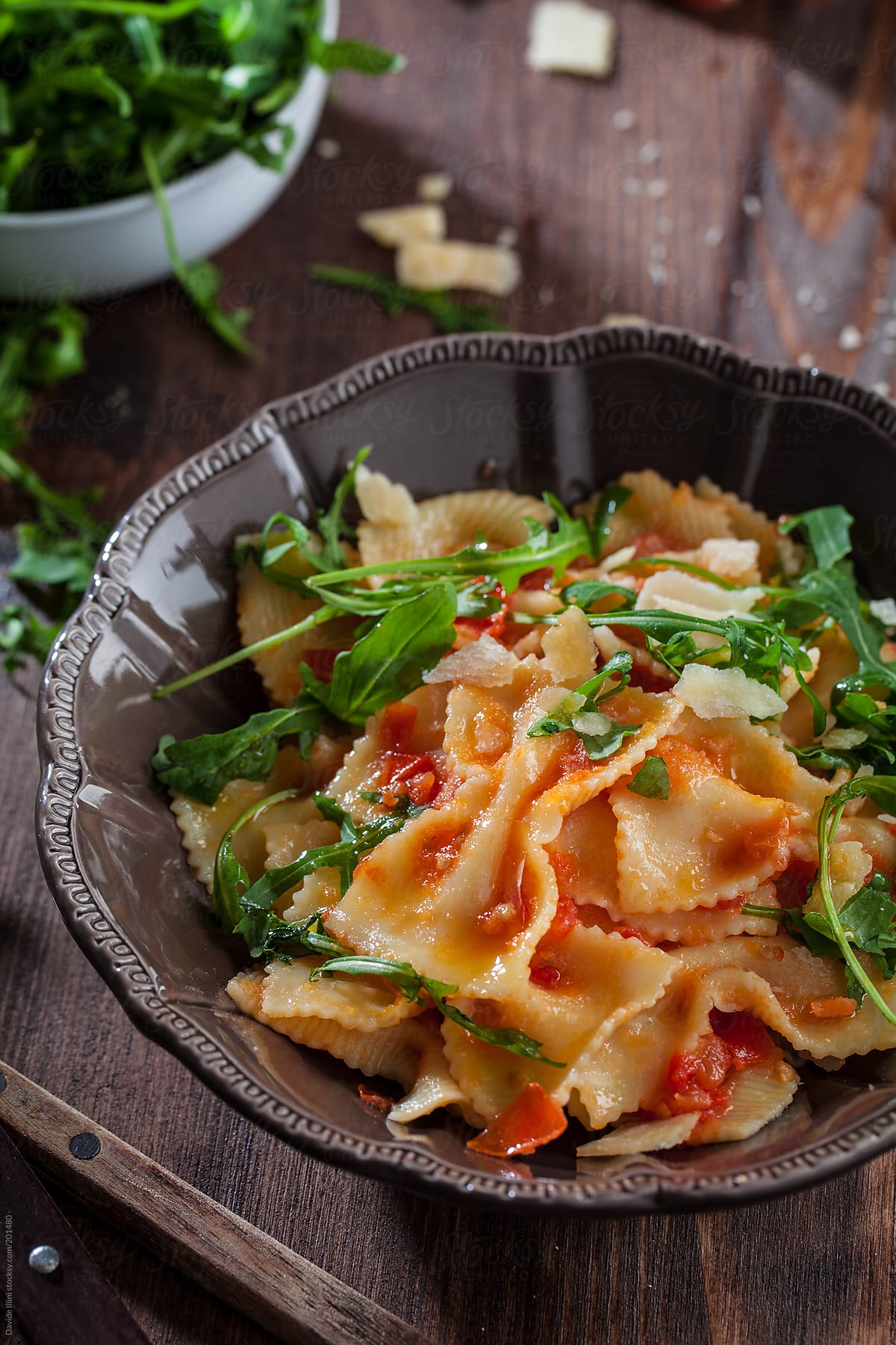 Pasta with tomato sauce and rocket salad