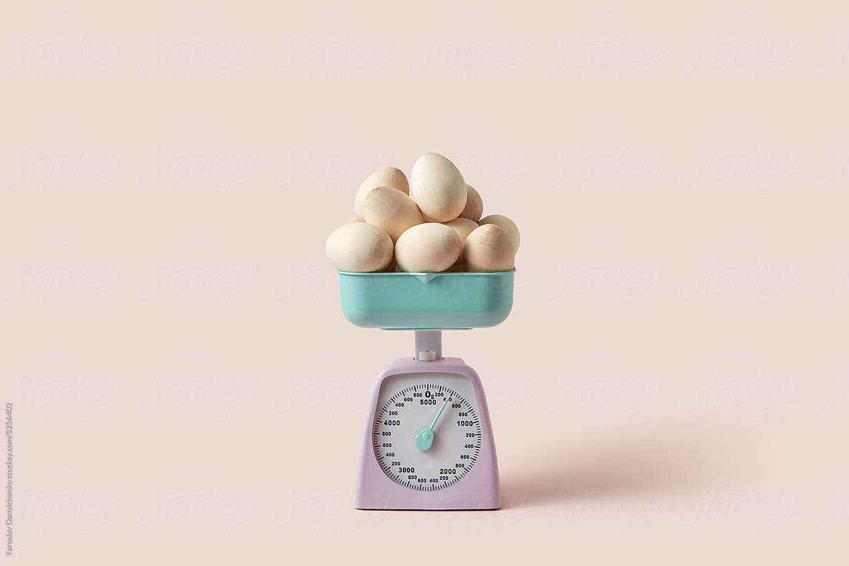 Wooden Easter eggs weighted on vintage scales.