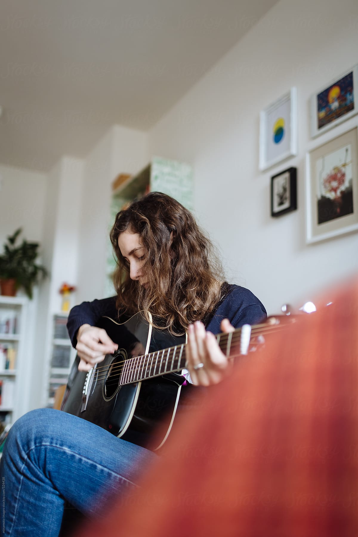 Pensive Woman Playing Guitar