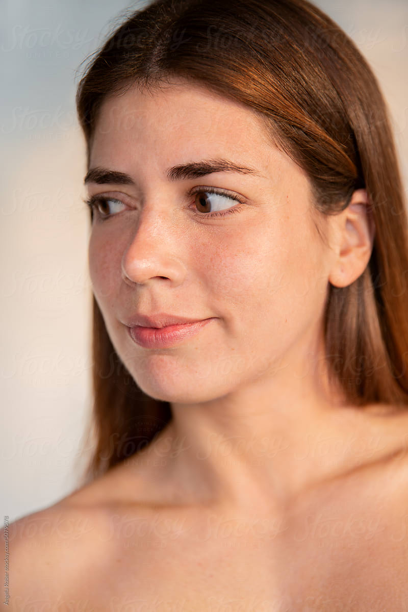 Vertical photograph of a woman illuminated with natural light