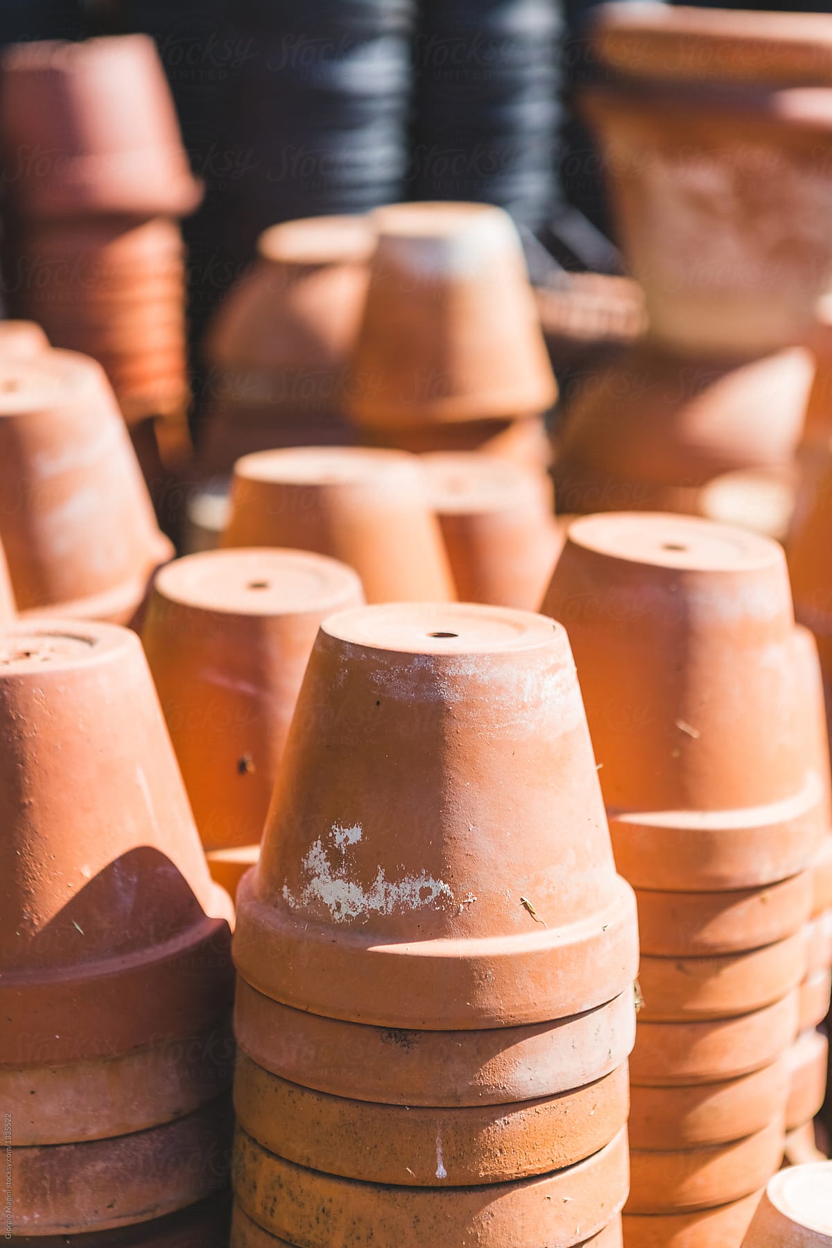 "Small Terracotta Pots Stacked Outdoors" by Stocksy Contributor