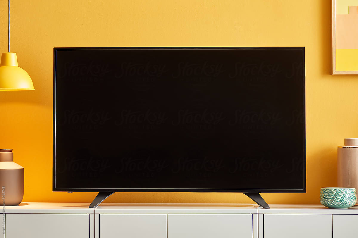 Empty screen of black TV on cabinet