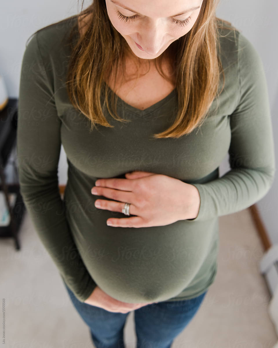 Young Pregnant Woman Holding Her Belly By Stocksy Contributor Lea Jones Stocksy