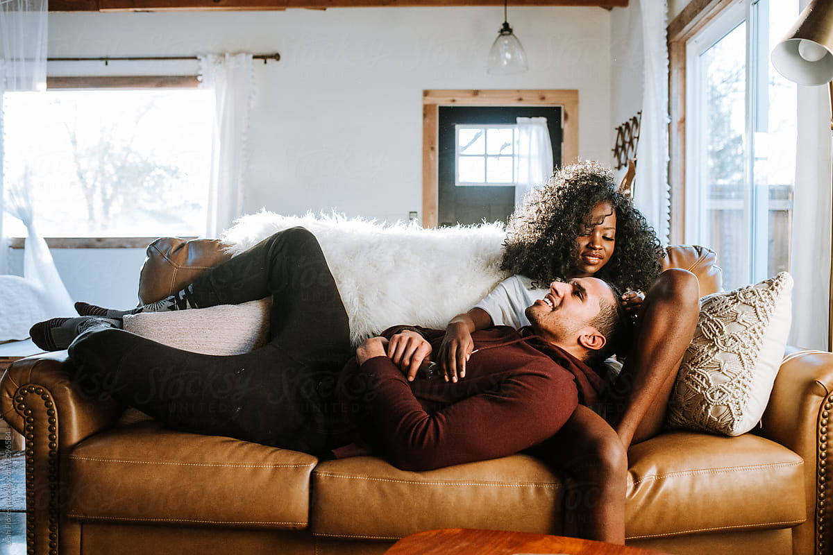 Couple Lounging Together On Couch by Leah Flores