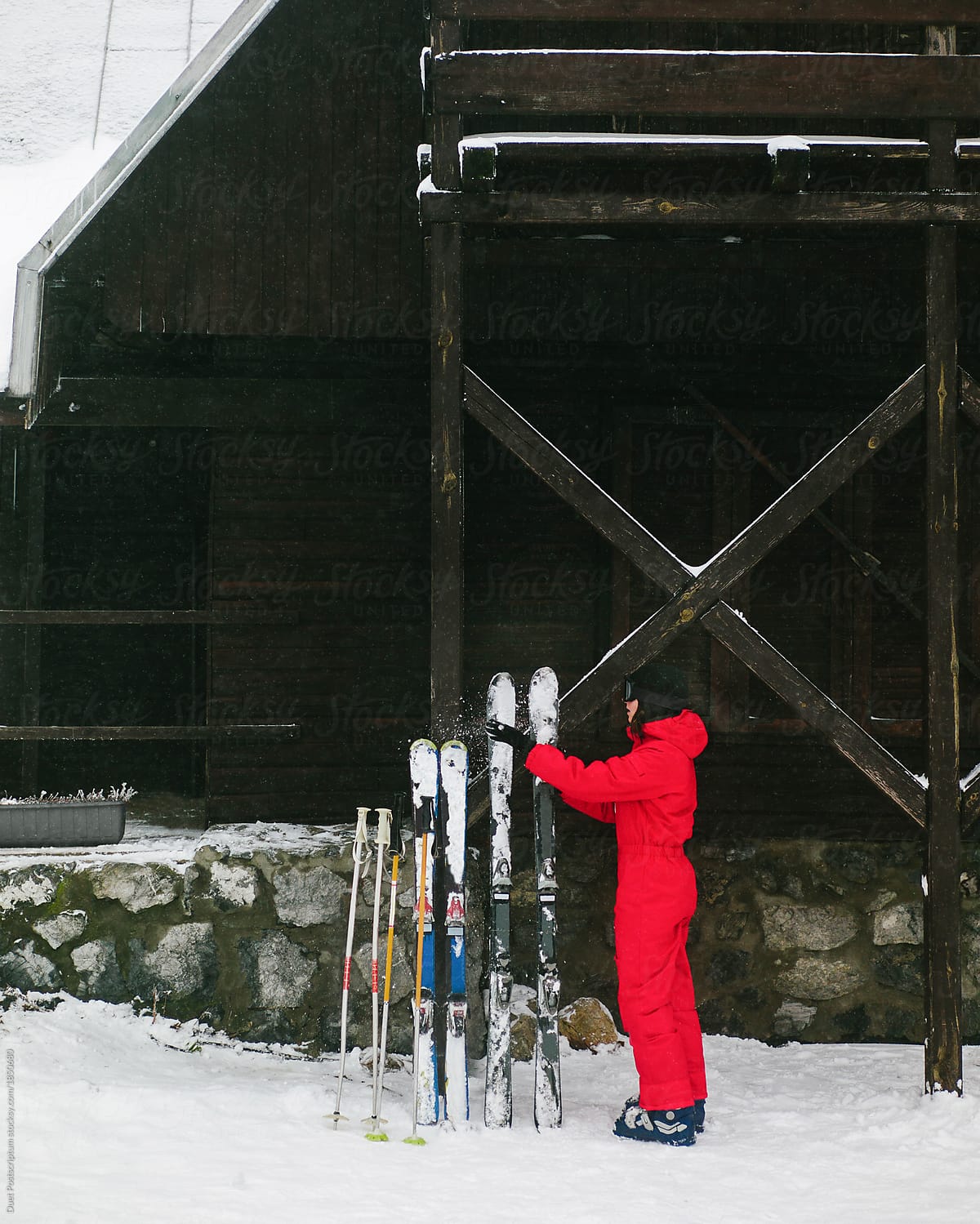Woman placing ski in snow