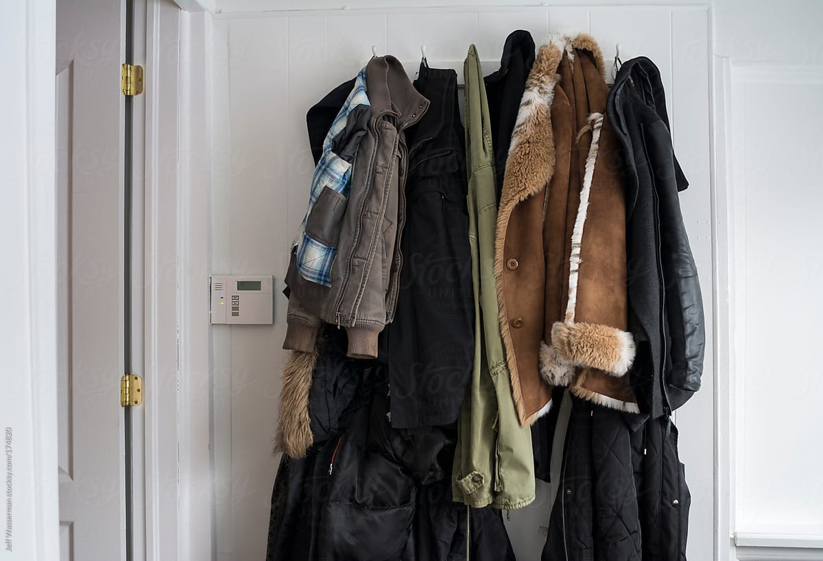 Coats Hanging on Rack and Security Alarm Panel