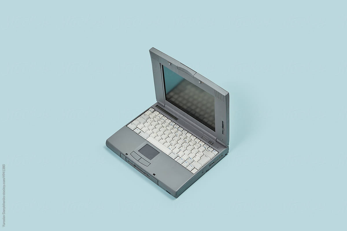 Old style laptop on blue background.