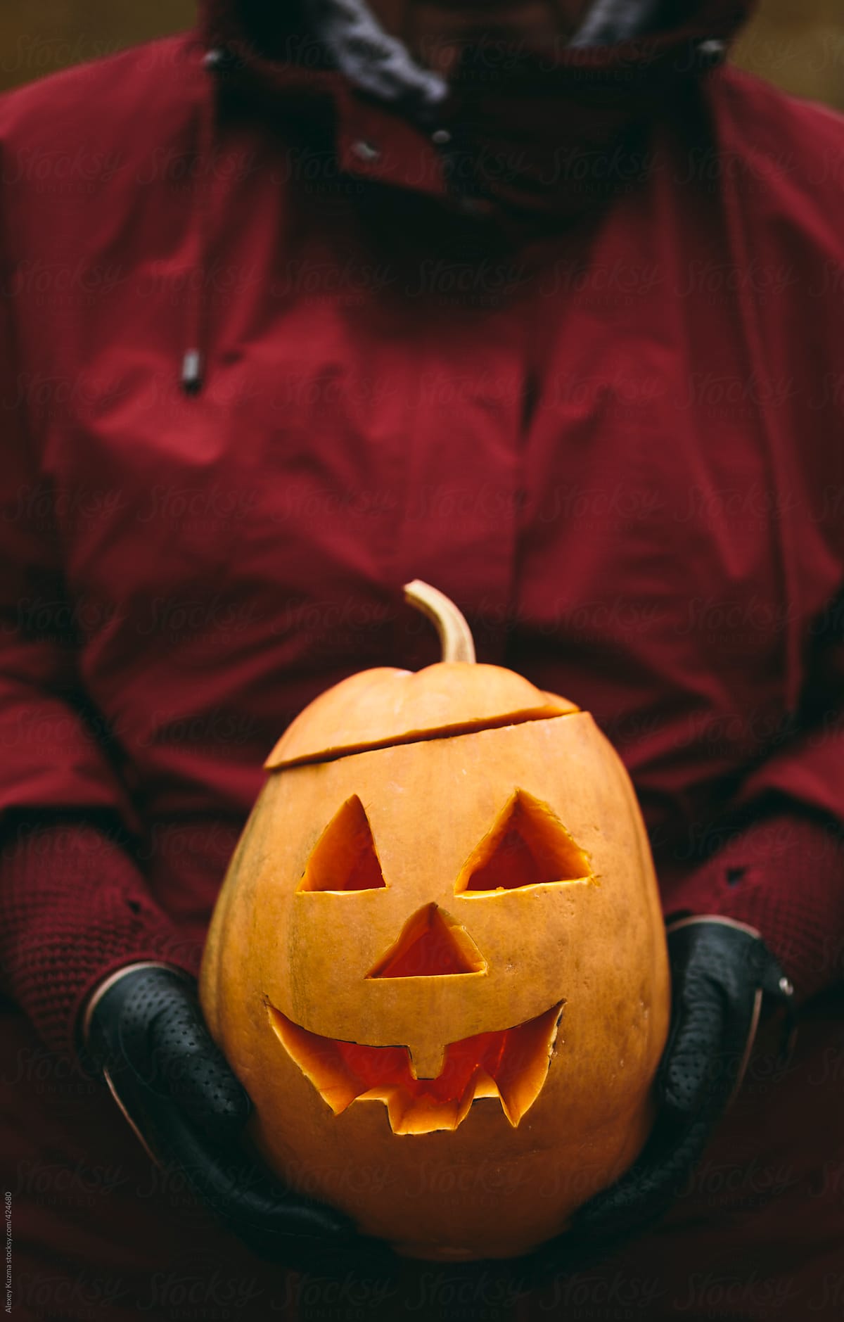 Woman holding Halloween Jack O\' Lantern pumpkin