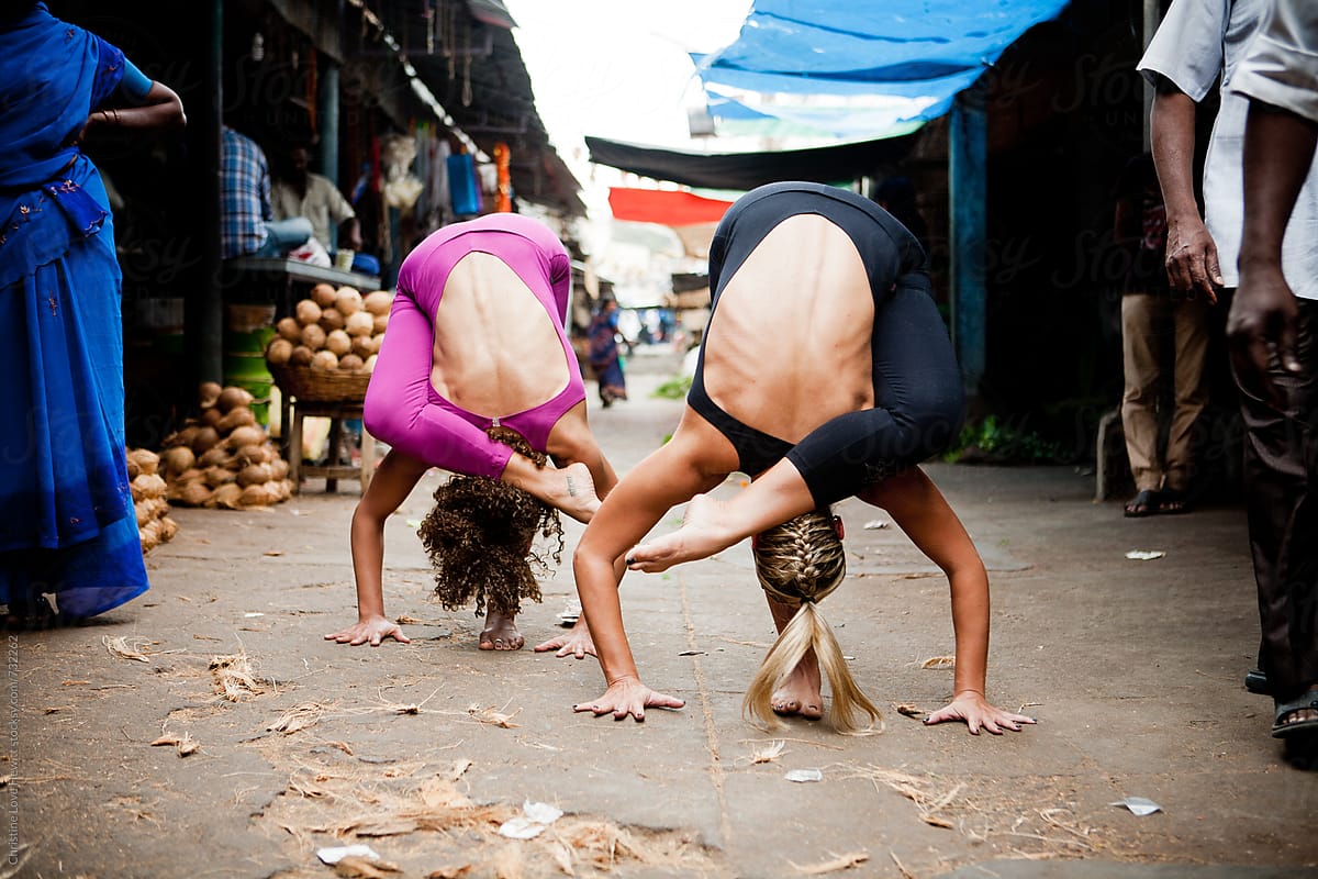 Two women doing yoga in a larket