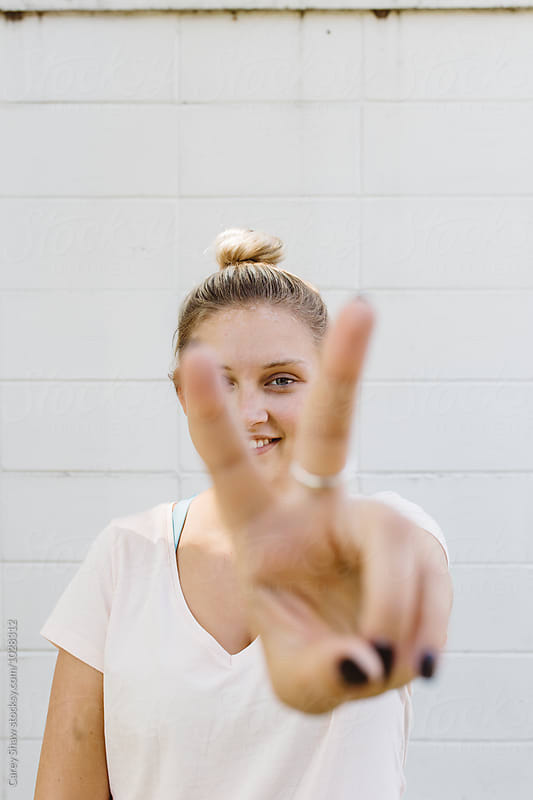 Young woman showing the peace sign