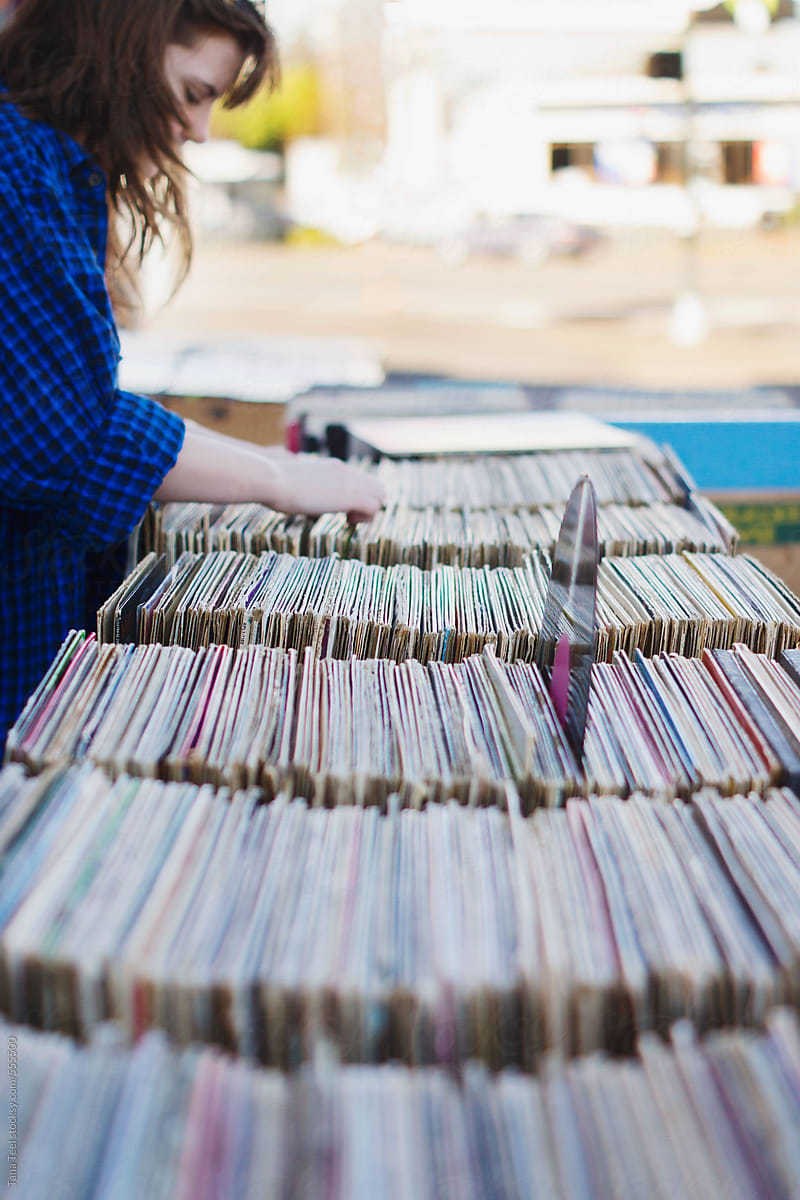 Teenager searches through vinyl lp record albums