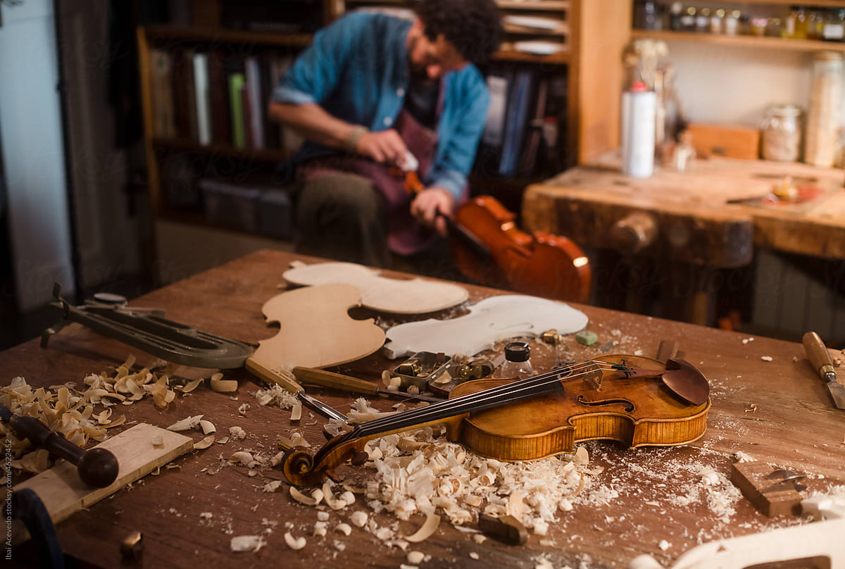 Luthier working on violin at studio