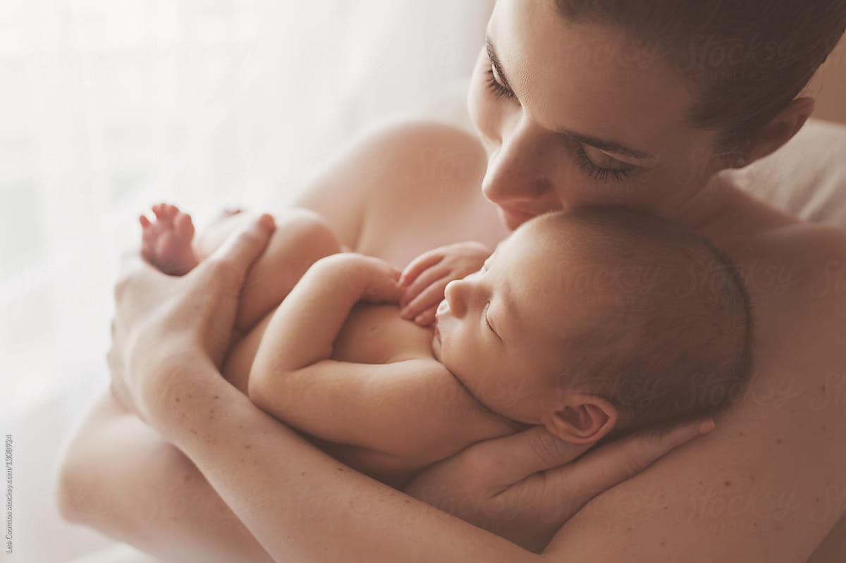 Beautiful Mother Snuggling With Her Naked Newborn Baby by Lea Csontos