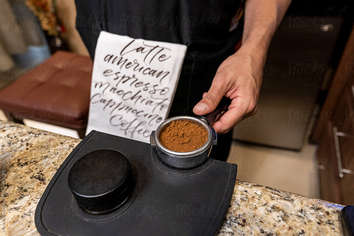 Person Making Coffee Holding a Filter Holder