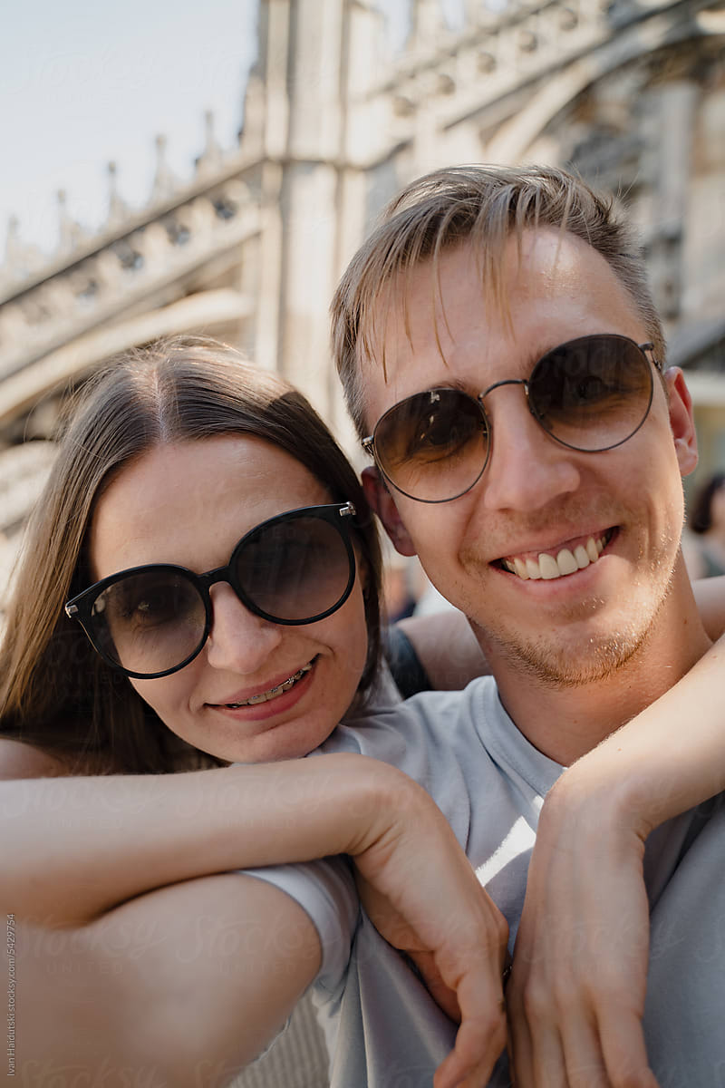 Happy couple in love captures a selfie on the rooftop of Milan Duomo