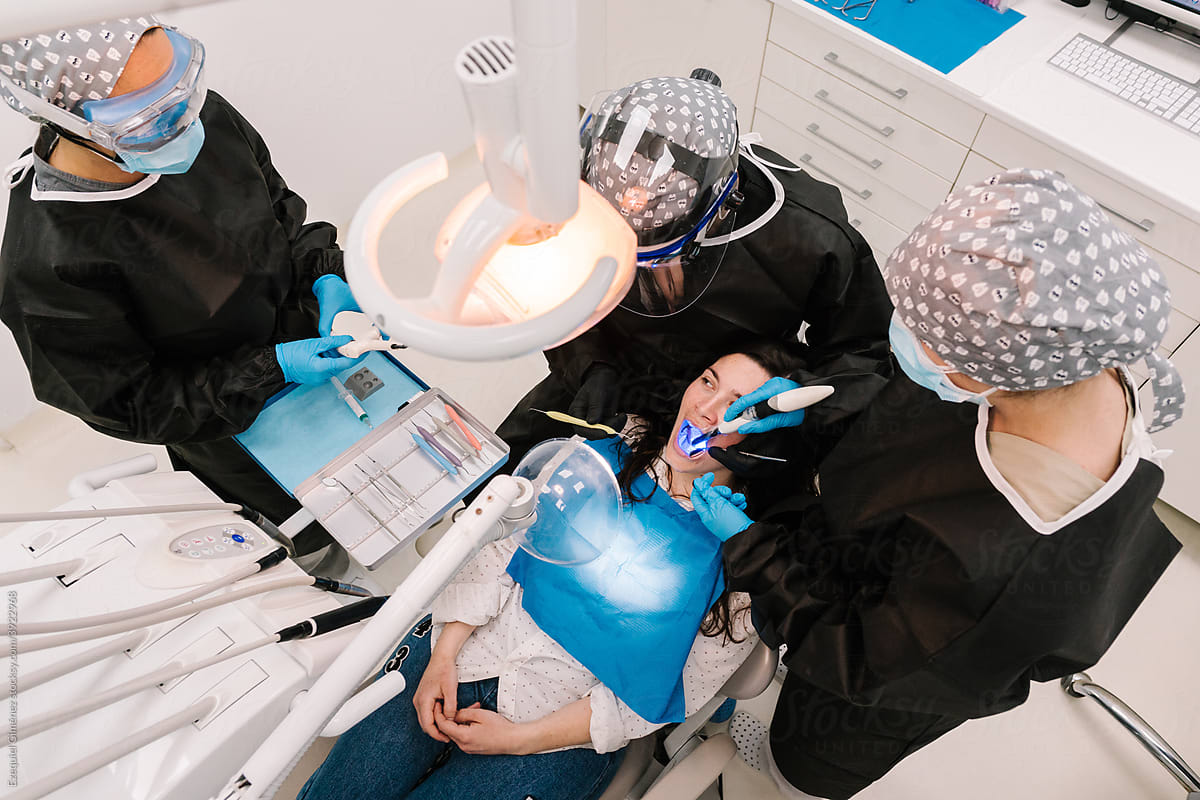 Dentists treating a patient at a clinic