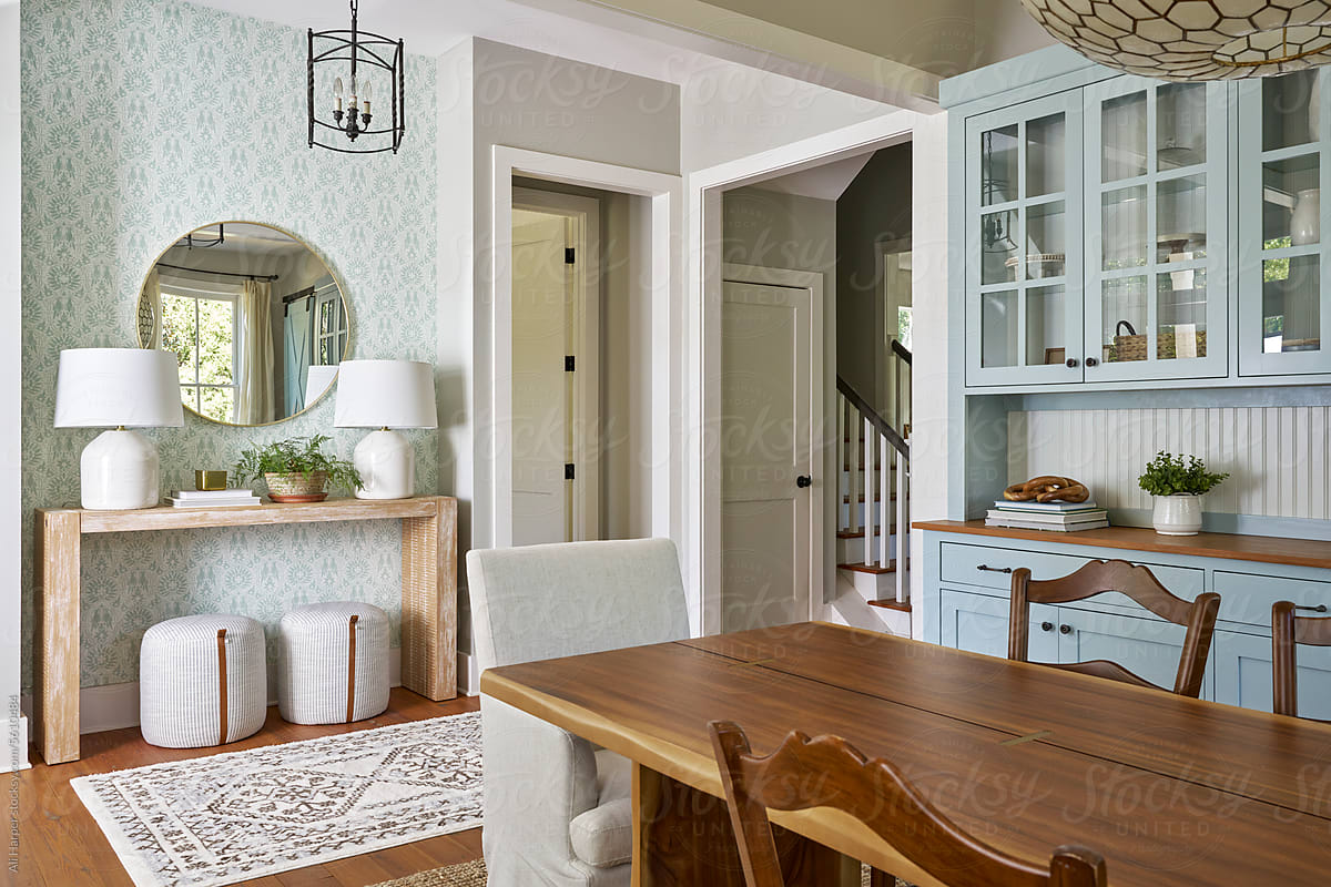 Cozy entryway and dining room with console table and china cabinet