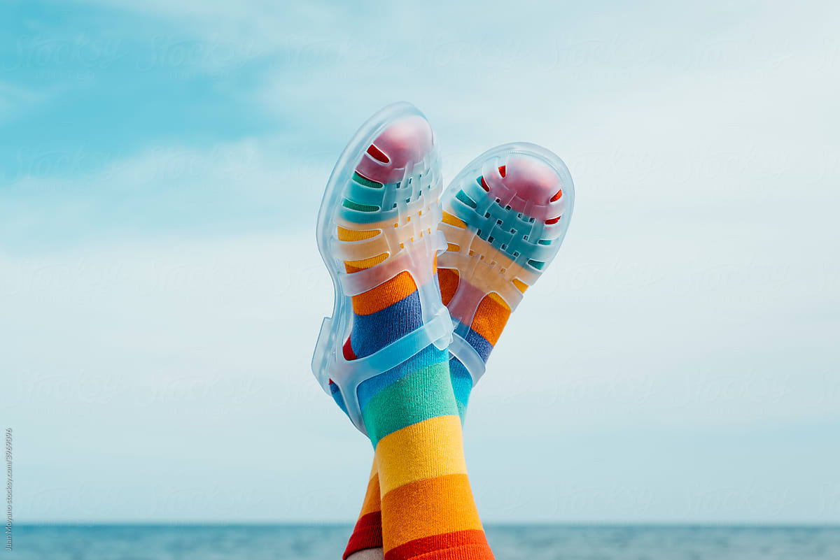 upside-down wearing rainbow patterned socks and sandals