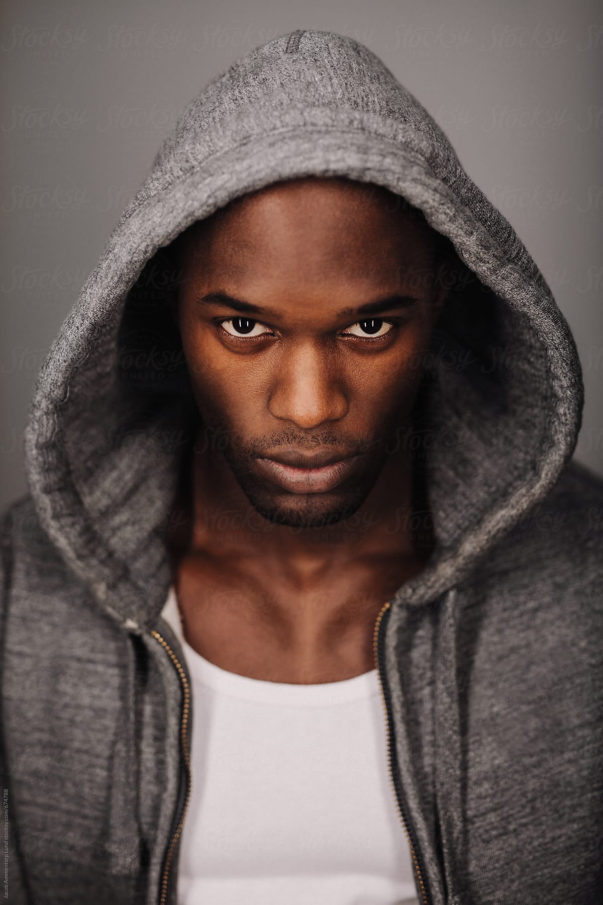 Serious young man in hooded sweatshirt