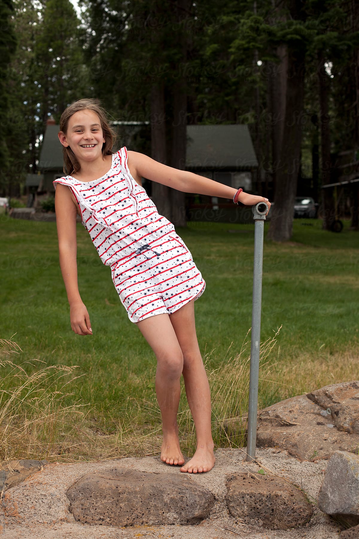 Ten Year Old Girl In Stars And Stripes Romper At A Cabin On A