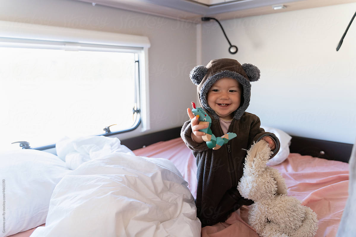 UGC, user-generated content. Cute happy baby on bed in motorhome