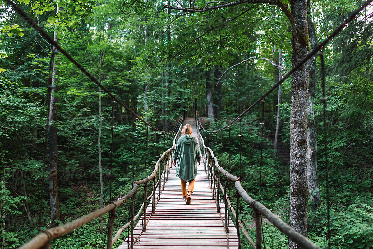 Woman Walking On A Bridge In Forest By Stocksy Contributor Alexander