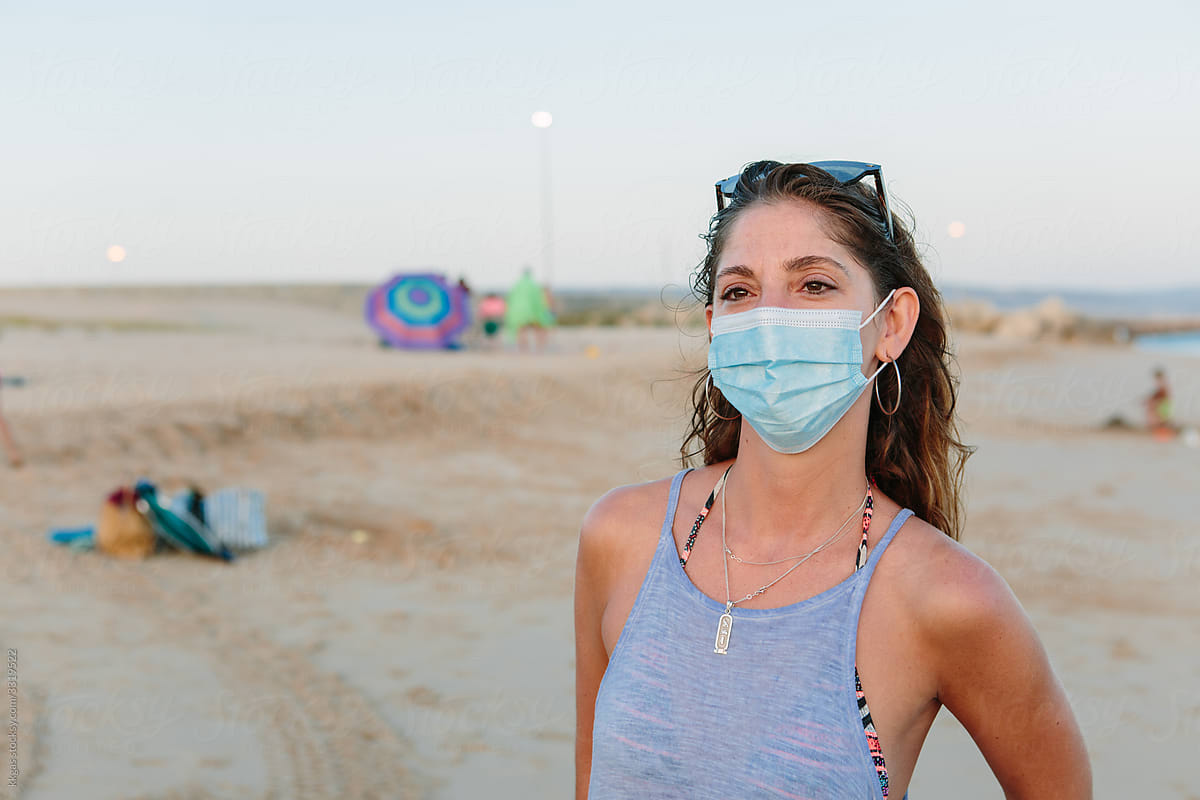 Woman in face mask on the beach
