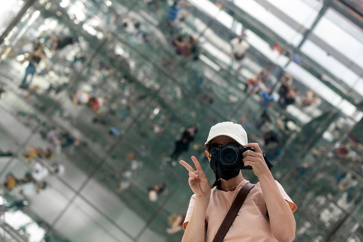 Happy tourist doing peace sign