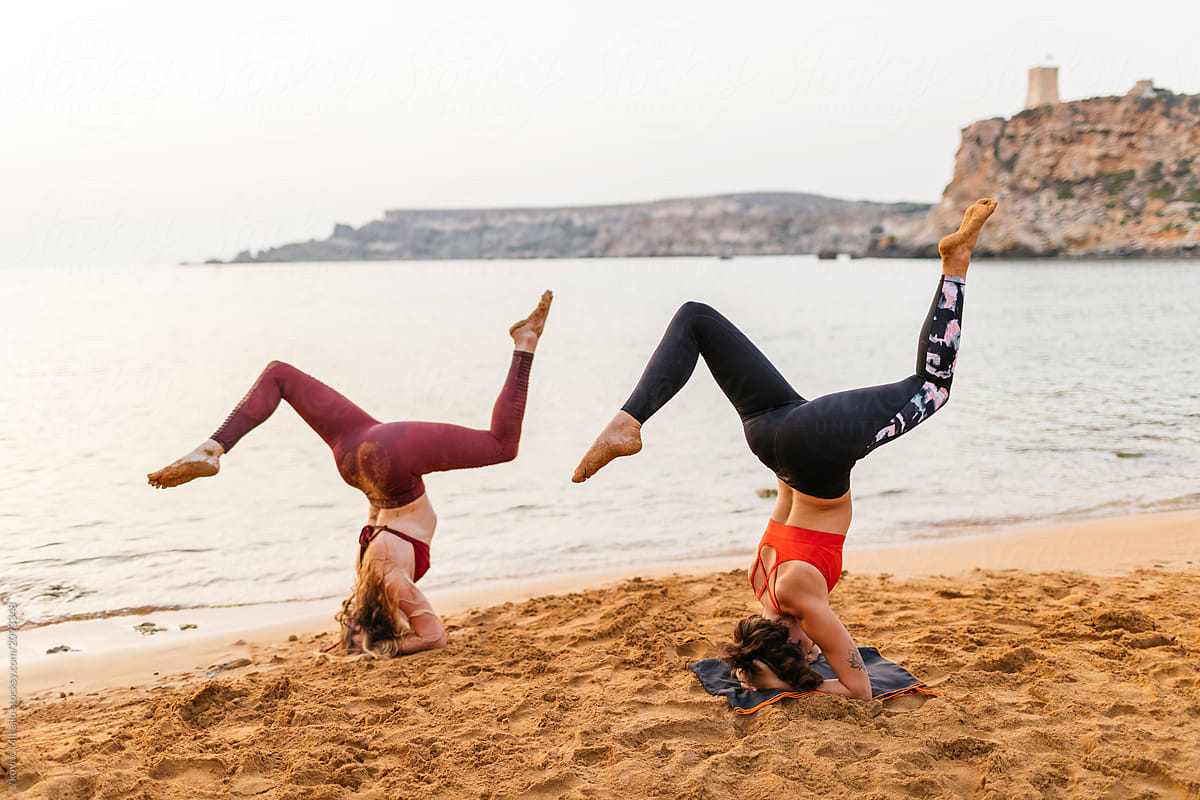 Two Young Woman Doing Acro Yoga At The Beach By Mihajlo Ckovric Group 
