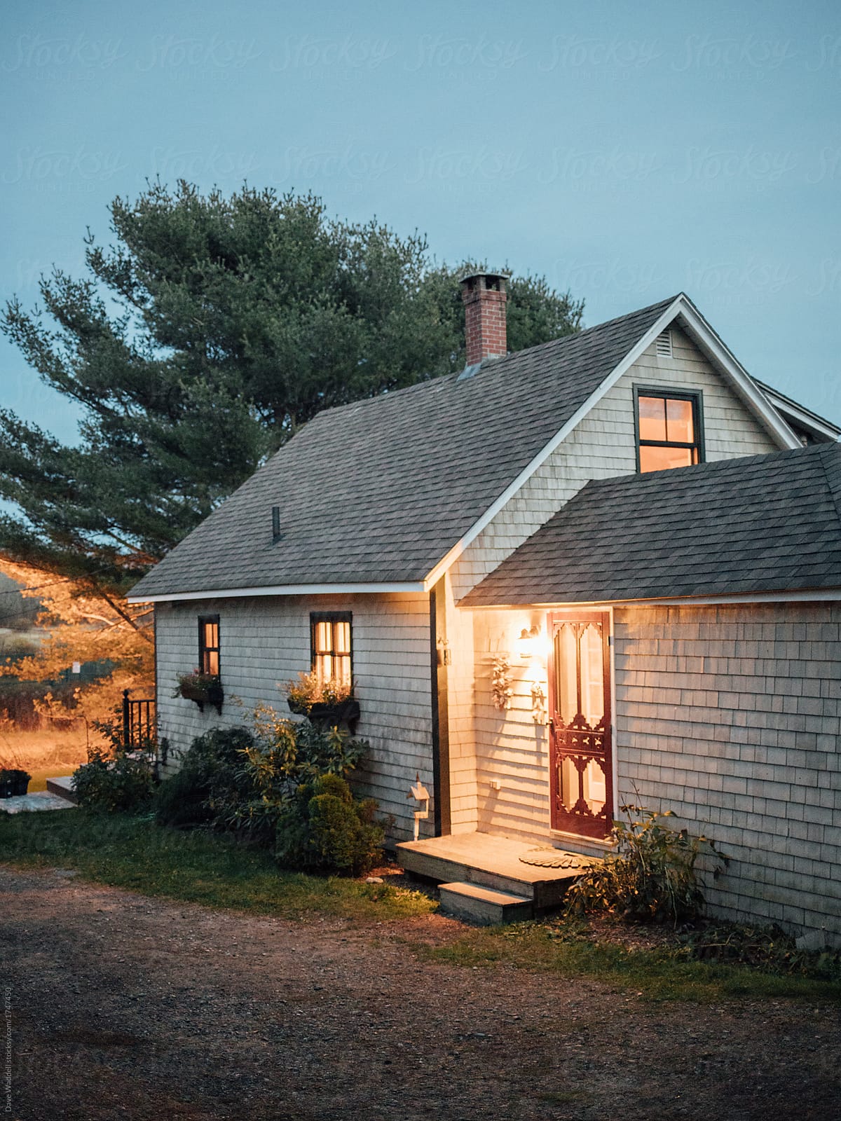 A cozy cottage in Maine at dusk.