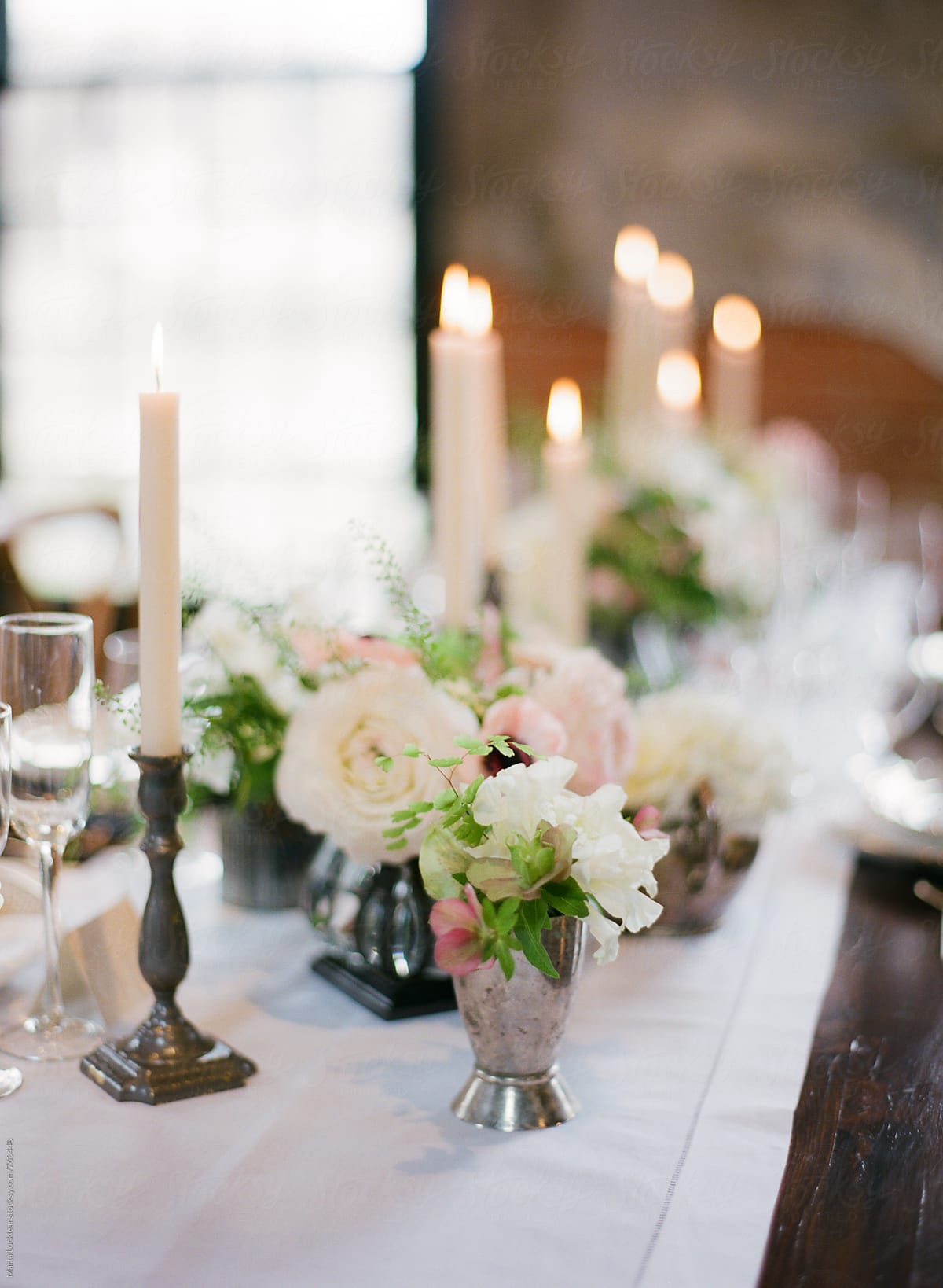 Floral arrangements and candlesticks on a formal dinner table