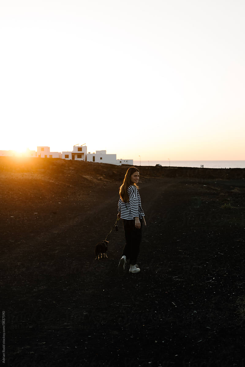 A young woman gazing at the sunset in the Canary Islands