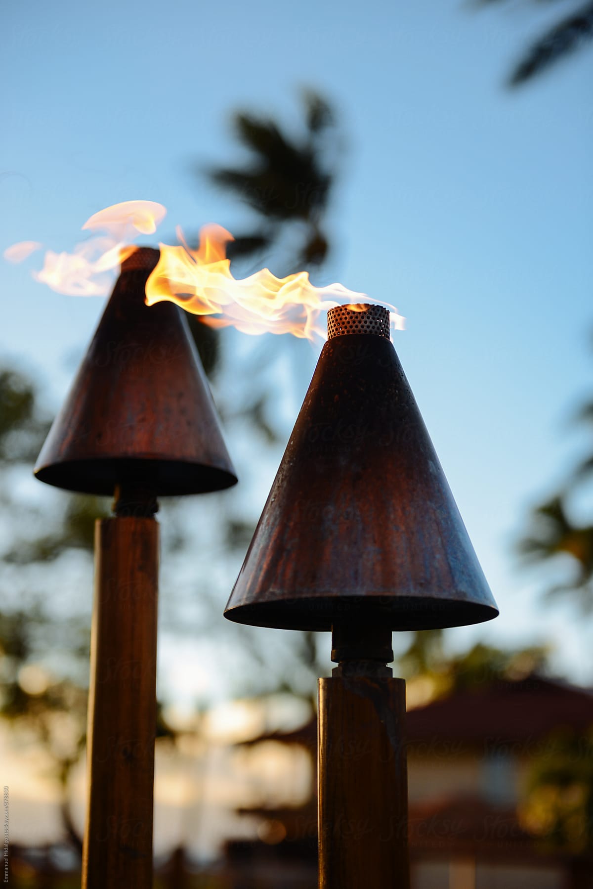 Closeup of two tiki torches lit on the island of Maui