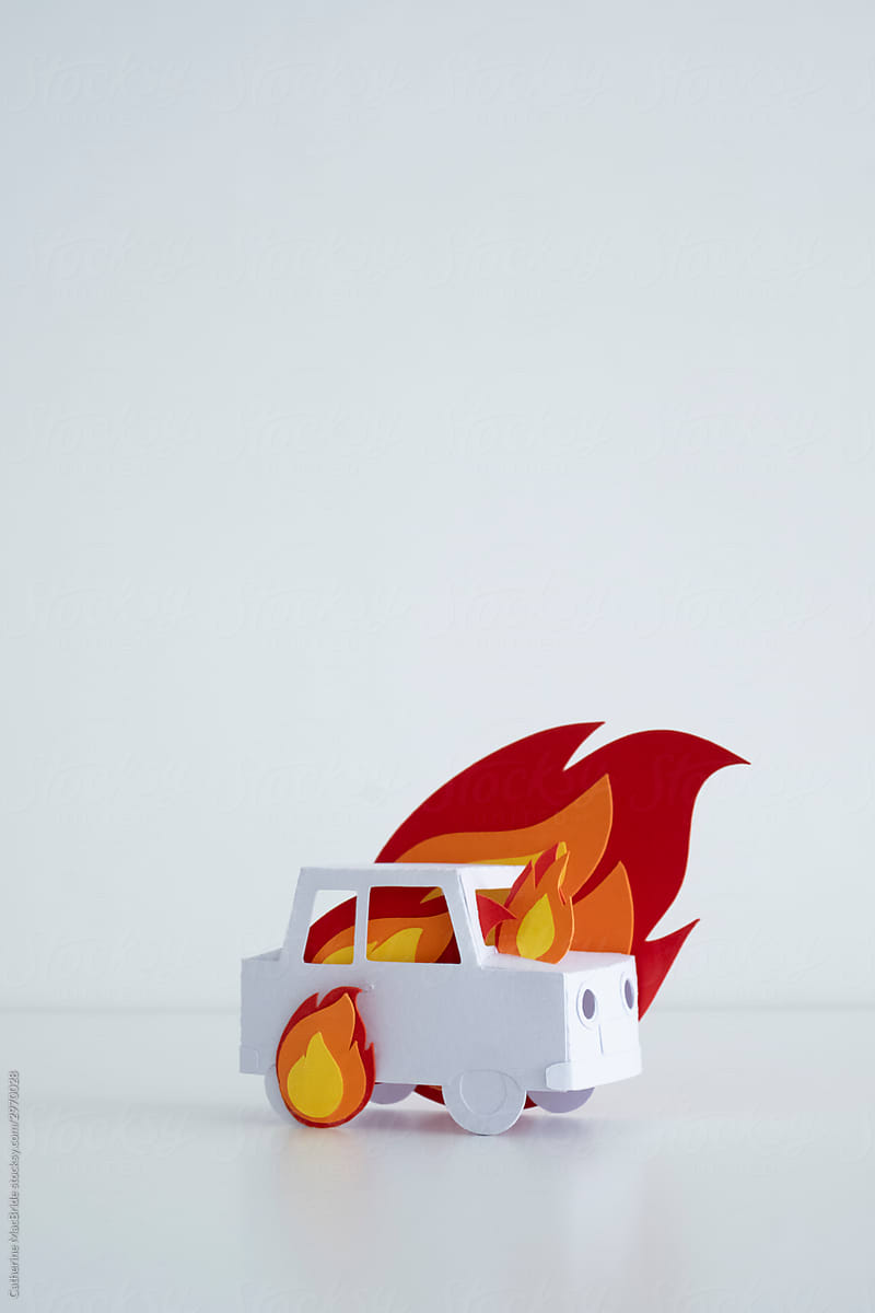 Stock photograph of paper craft car on fire with bright paper flames