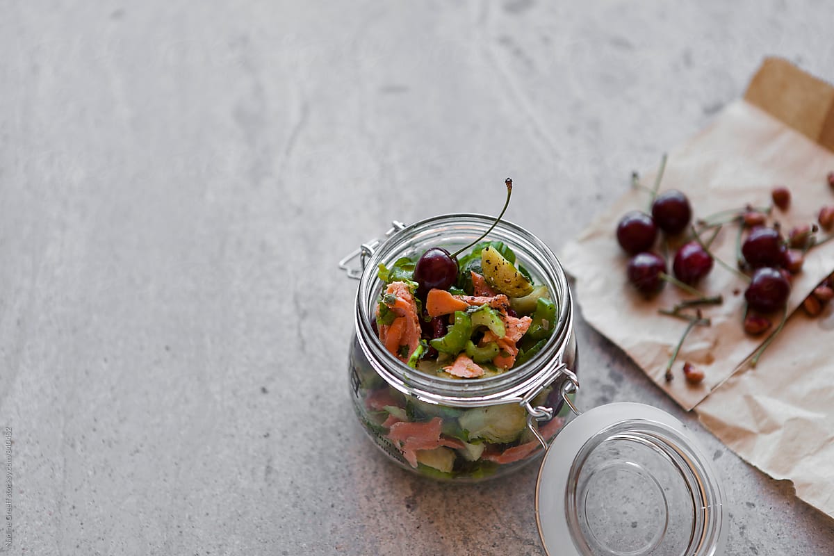 Jar with brussel sprout, salmon and cherry salad
